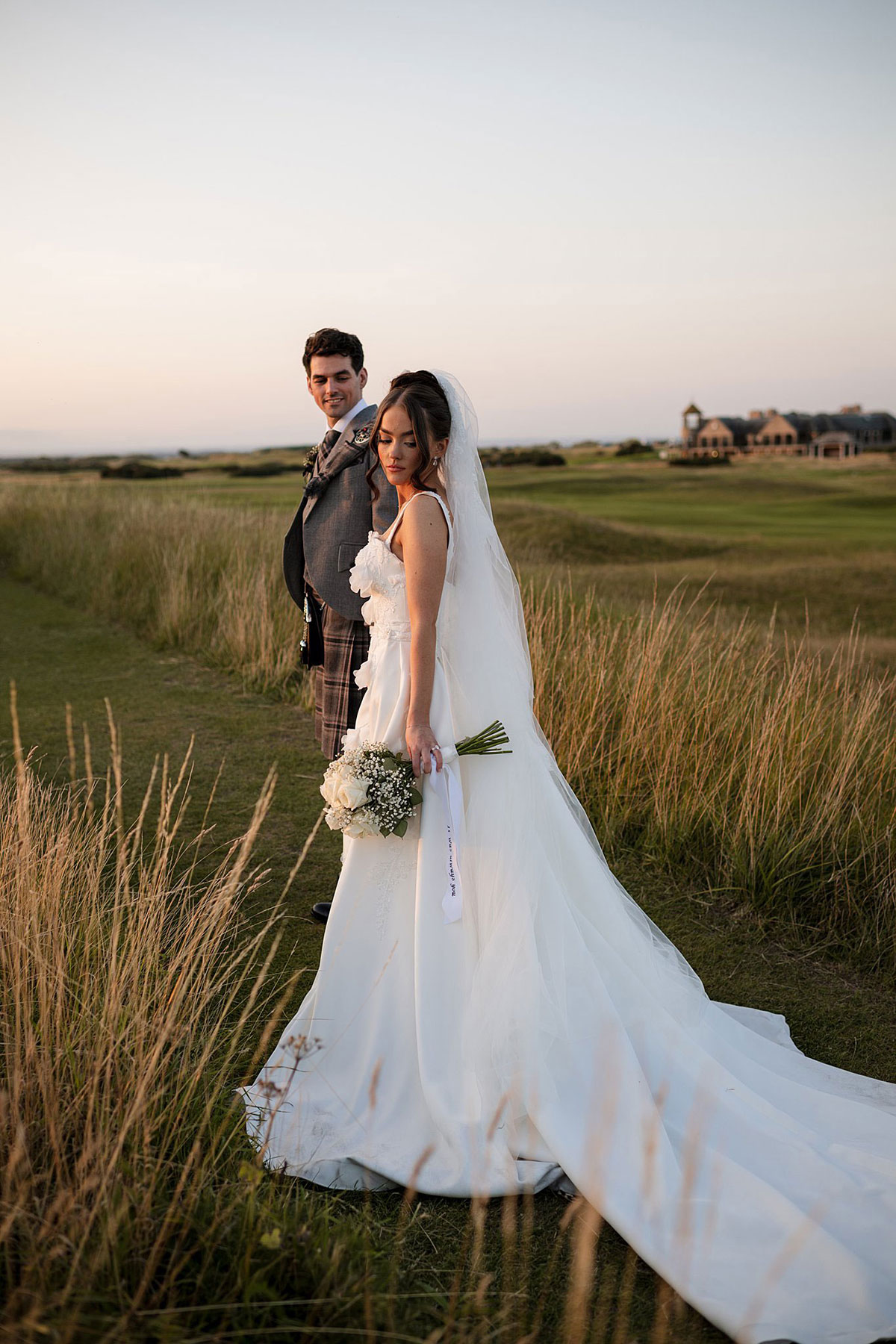 Bride and groom portrait on the famous Old Course golf links at sunset during Old Course Hotel St Andrews wedding.