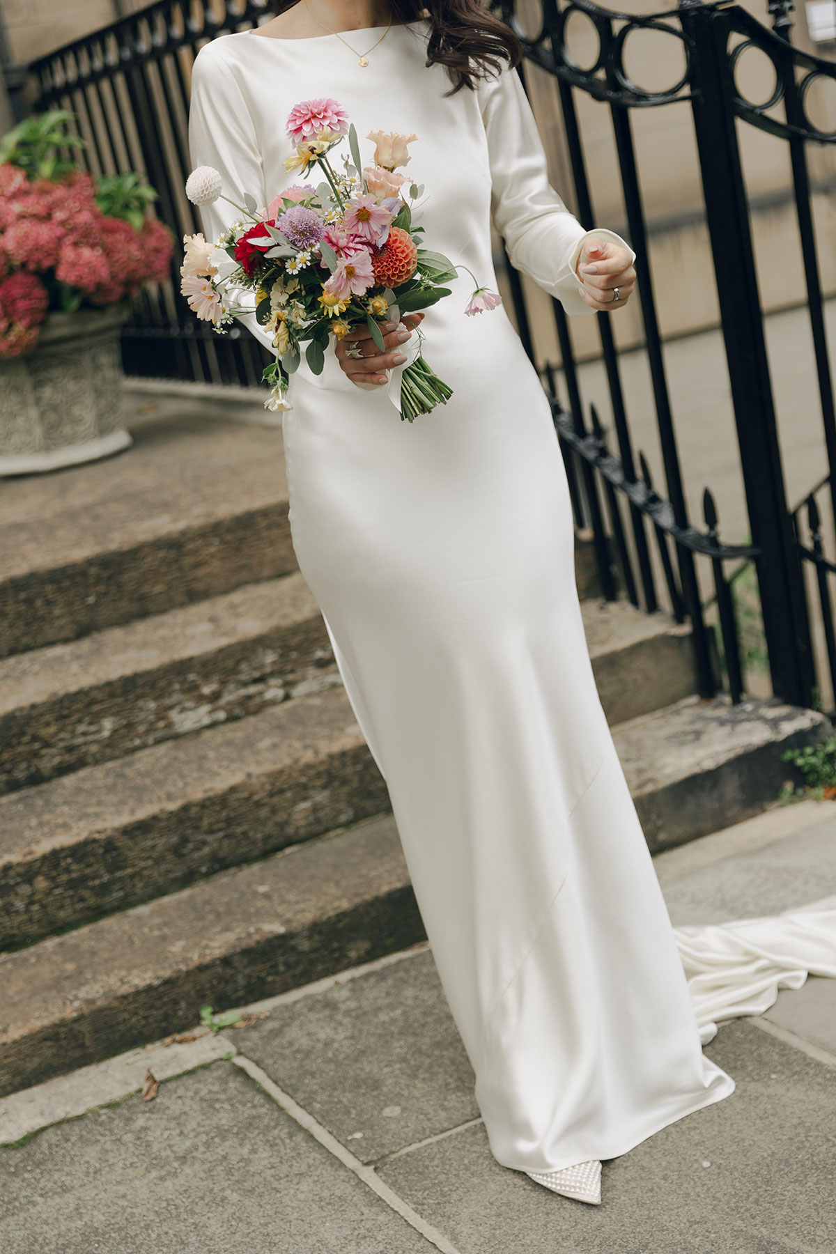 Bride holding a colourful, seasonal wedding bouquet during an intimate Edinburgh city wedding