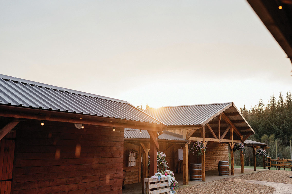 Rustic barn courtyard at Eden Leisure Village, a blank canvas wedding venue near Glasgow surrounded by woodland.