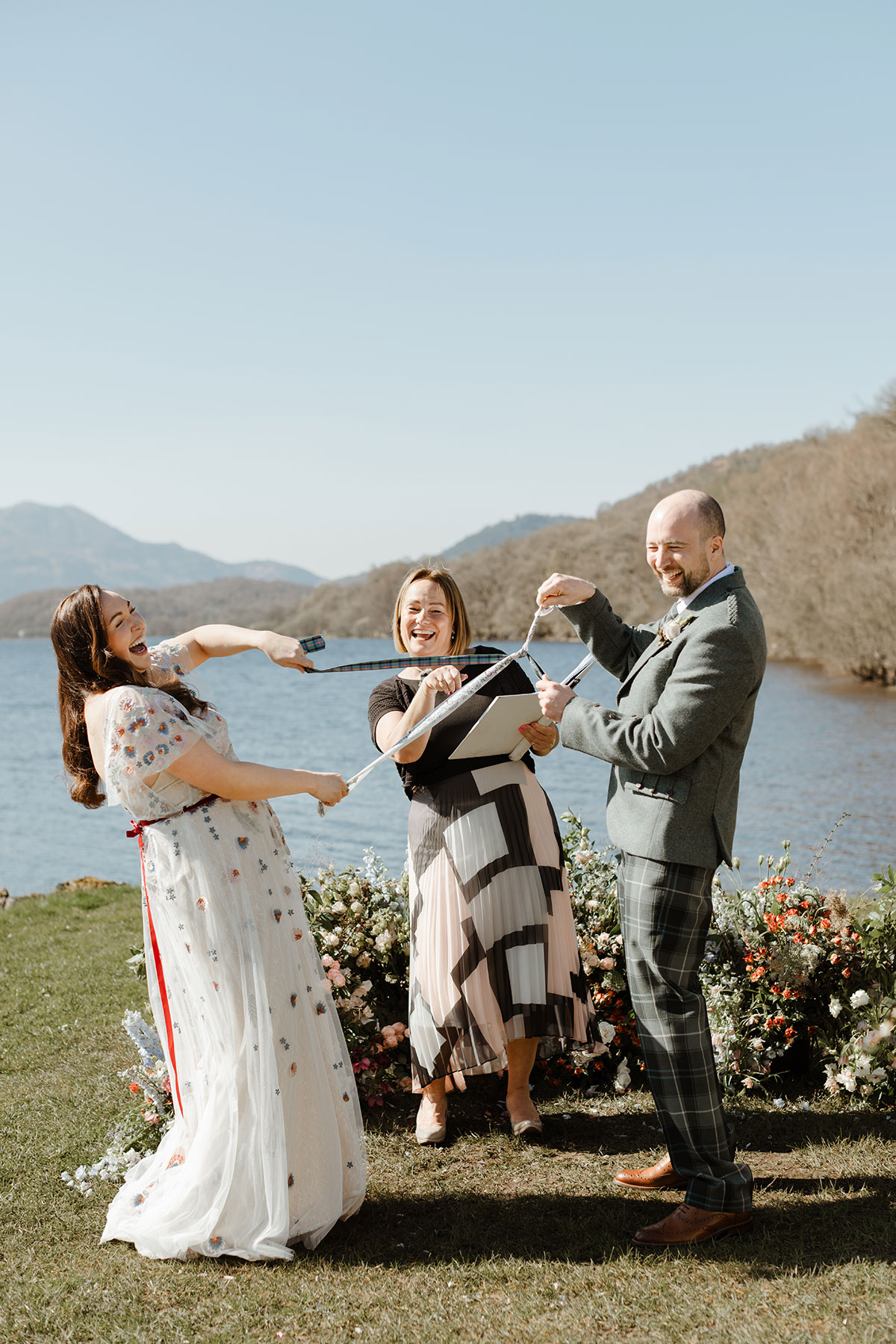 Bride and groom handfasting with officiant in the middle