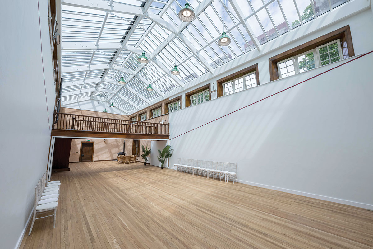 Wide view of Fyvie Castle’s Racquets Court showing its glazed roof, sprung wooden floor and balcony