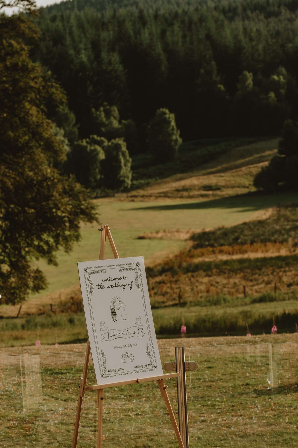 Illustrated wedding welcome sign overlooking the countryside surrounding Ballogie House