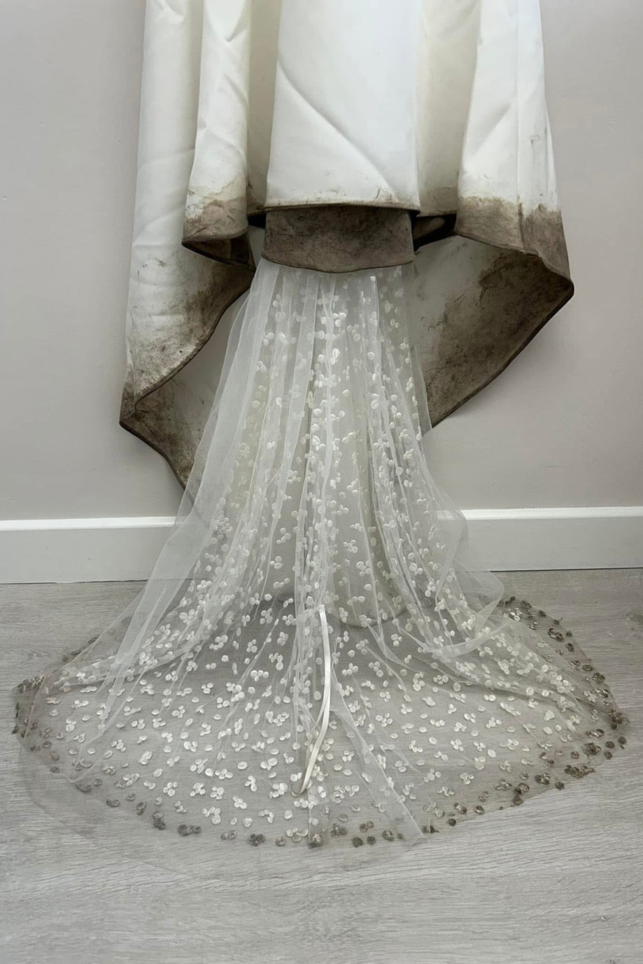 a wedding dress with a dirty hem