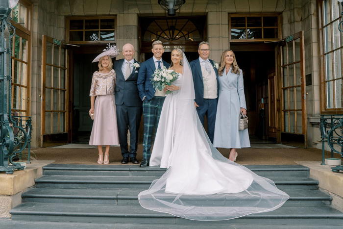 Bride and groom with their parents on steps at Gleneagles
