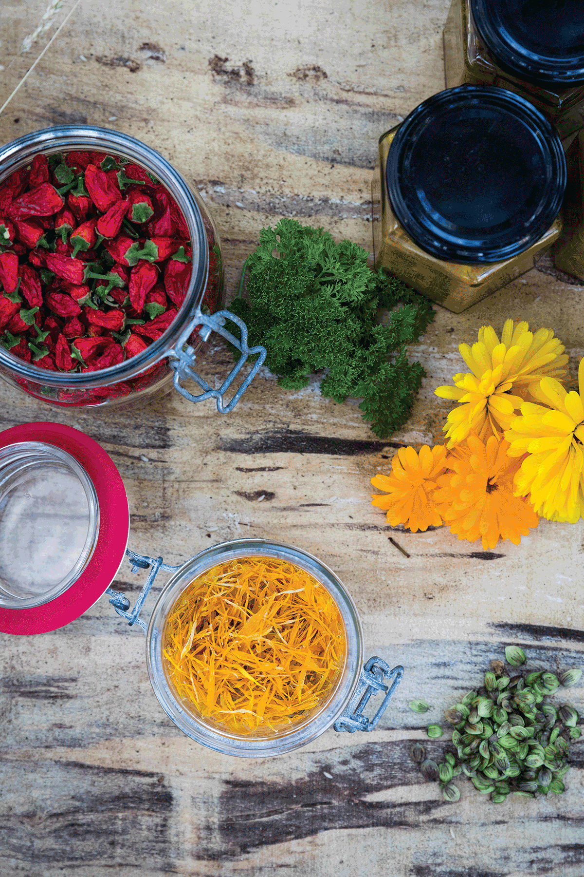 A flatlay of jars of produce and flowers
