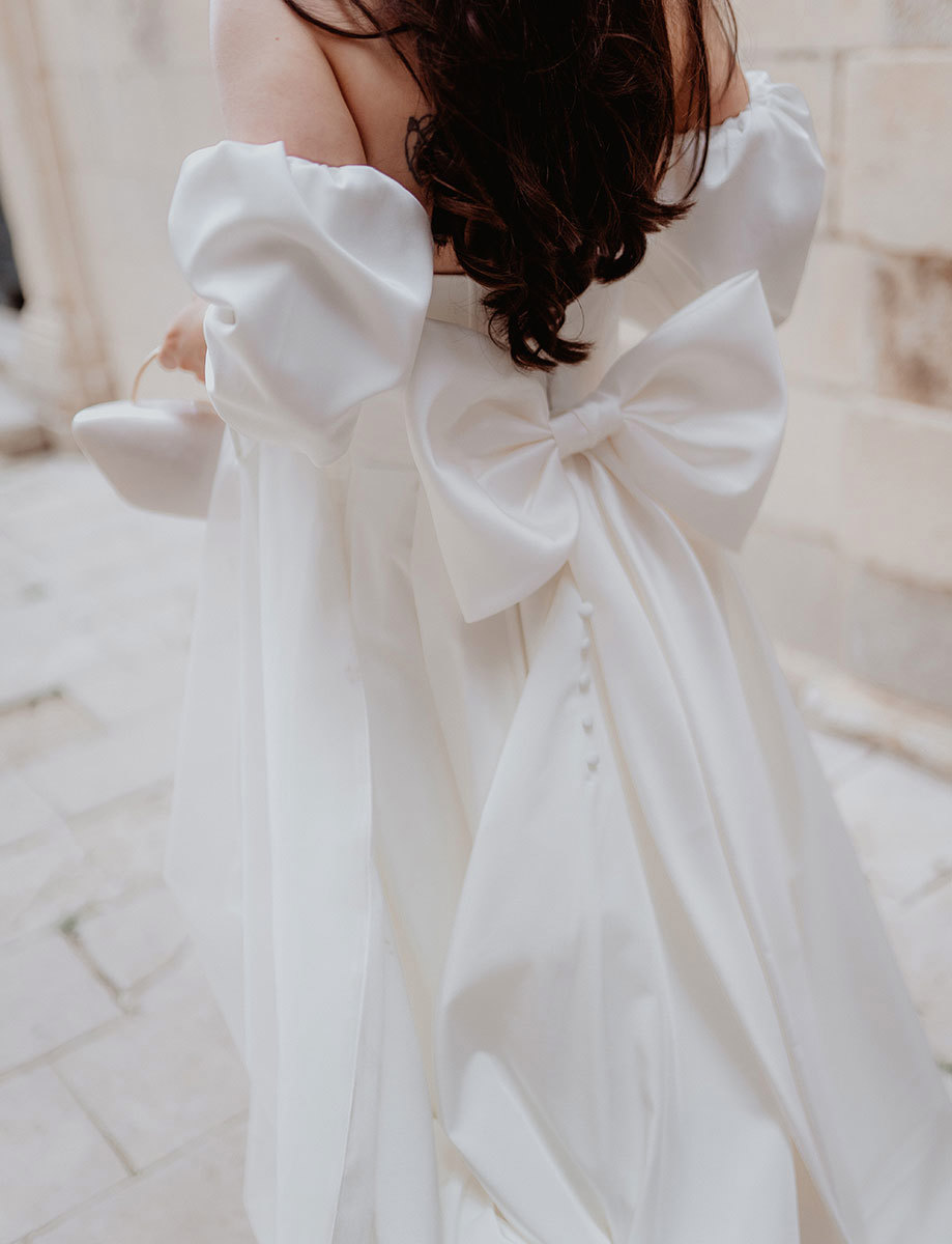 a large bow on the back of a wedding dress