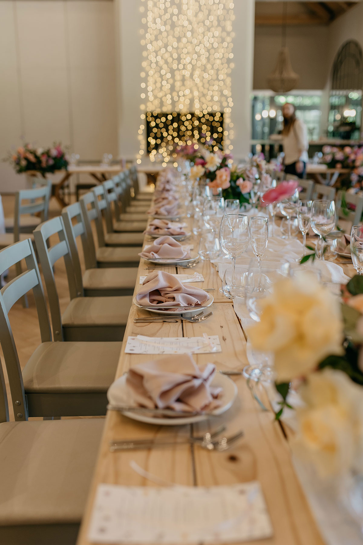 Elegant wedding reception table styling with blush napkins, floral centrepieces and fairy lights at Boschendal Wine Estate in South Africa
