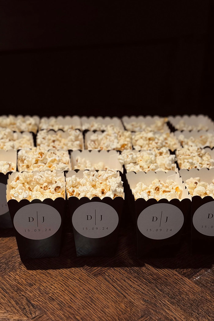 popcorn in black boxes set up on table