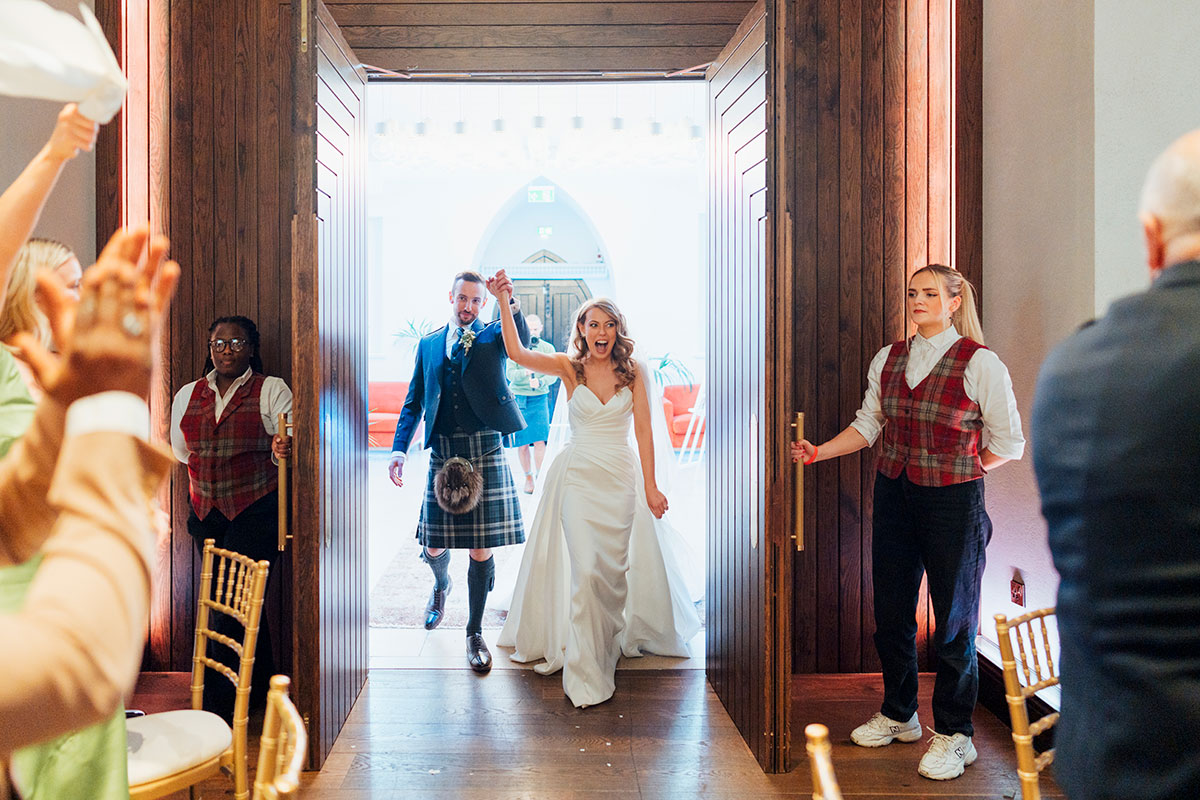 bride and groom enter dinner at Virgin Hotels Edinburgh wedding