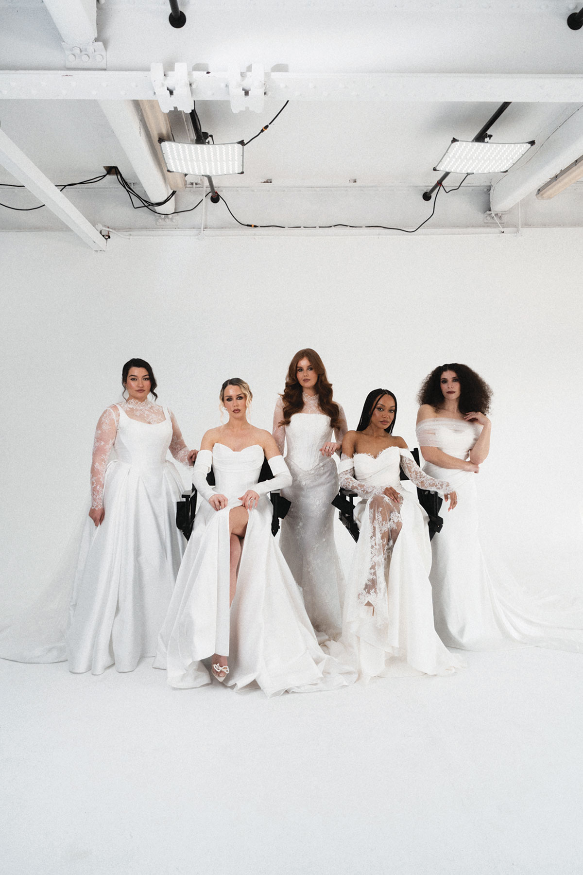 Models wearing modern wedding dresses from Opus Couture's exclusive bridal collection in a studio photoshoot