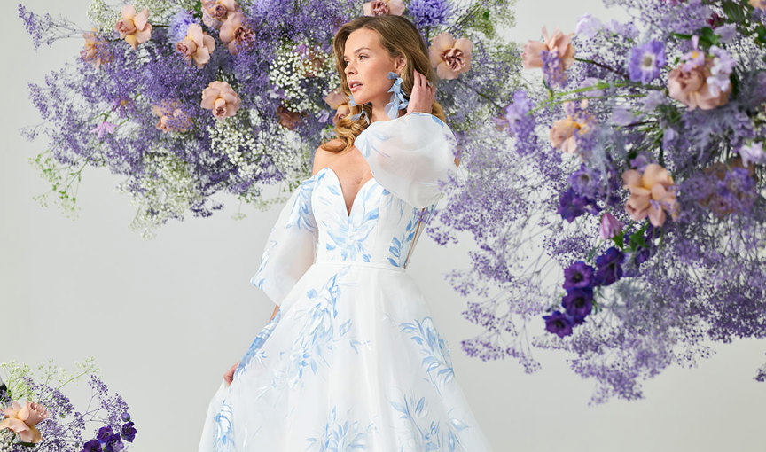 a person wearing a white dress with blue floral pattern 