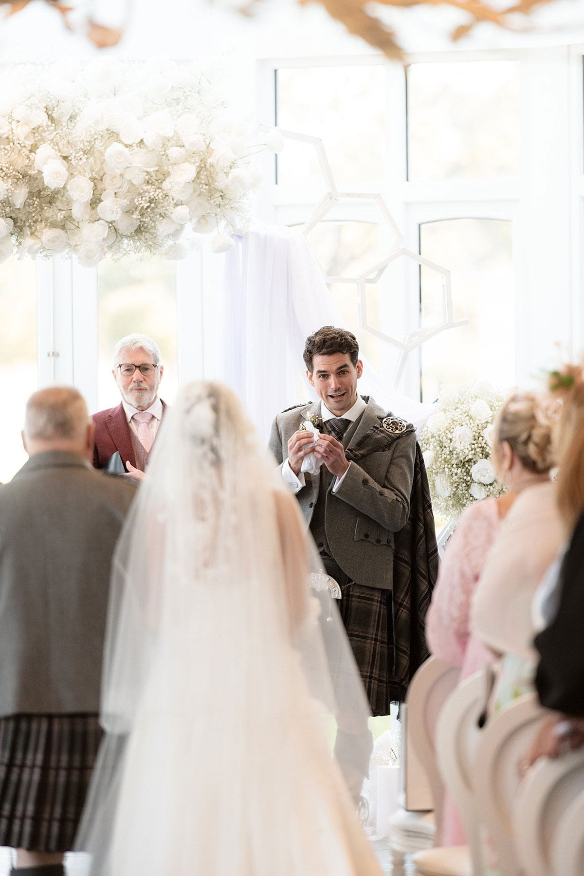 Emotional groom reacting during humanist wedding ceremony in the conservatory at Old Course Hotel St Andrews.
