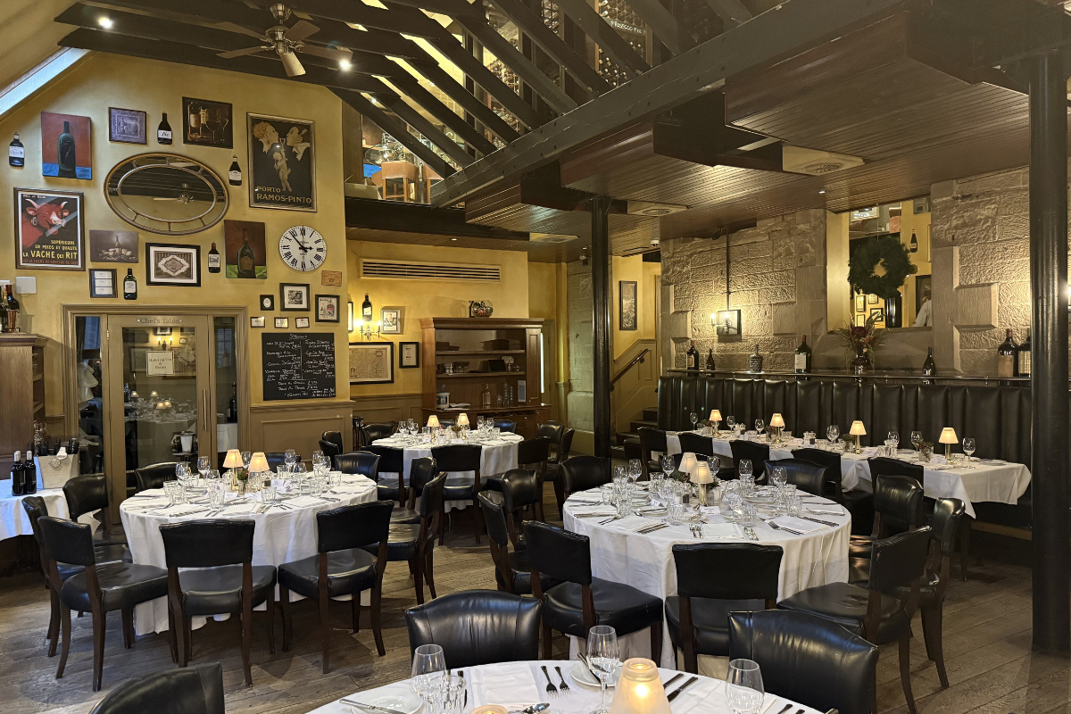 Wedding reception at Hotel du Vin Edinburgh with round dining tables, candlelight and characterful interiors