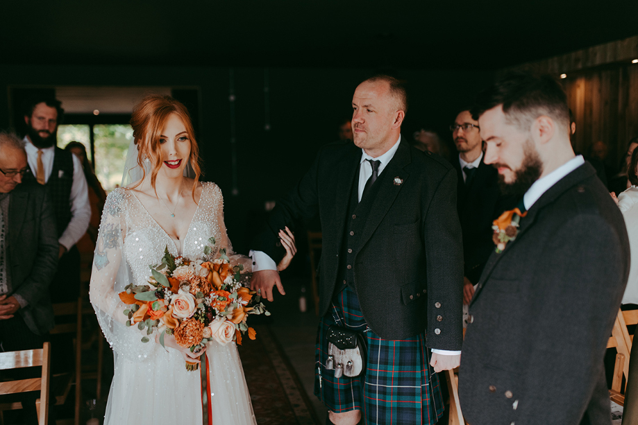 Bride's brother walks her down the aisle to meet groom