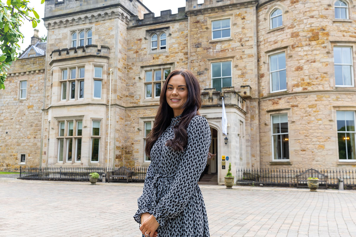Wedding coordinator standing outside a Scottish castle wedding venue courtyard