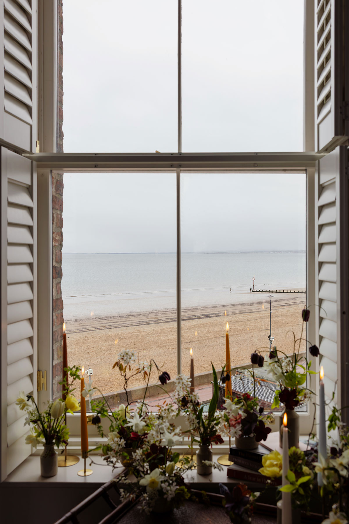 Wedding flowers on window ledge with Portobello beach view at The Tower