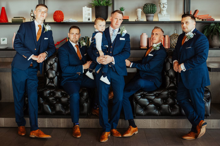 Groom and ushers with small boy in matching suit