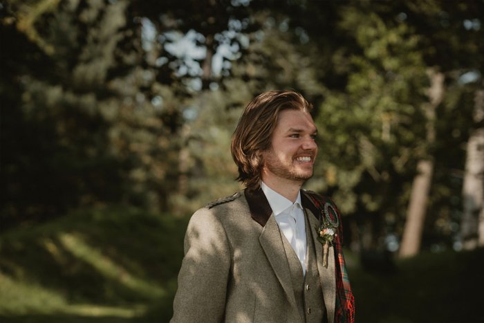 A Groom Smiling In The Grounds Of Hartree Estates