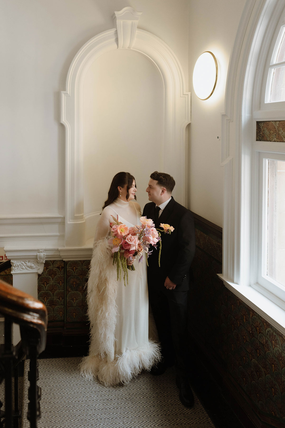 Bride and groom portrait on a historic staircase after their Glasgow wedding ceremony