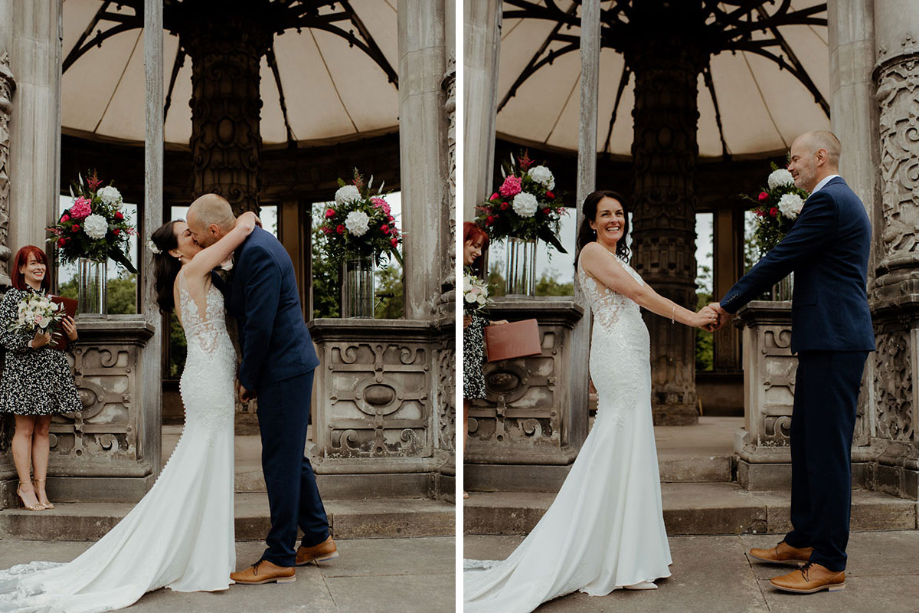 Bride and groom hold hands and share a kiss during the ceremony