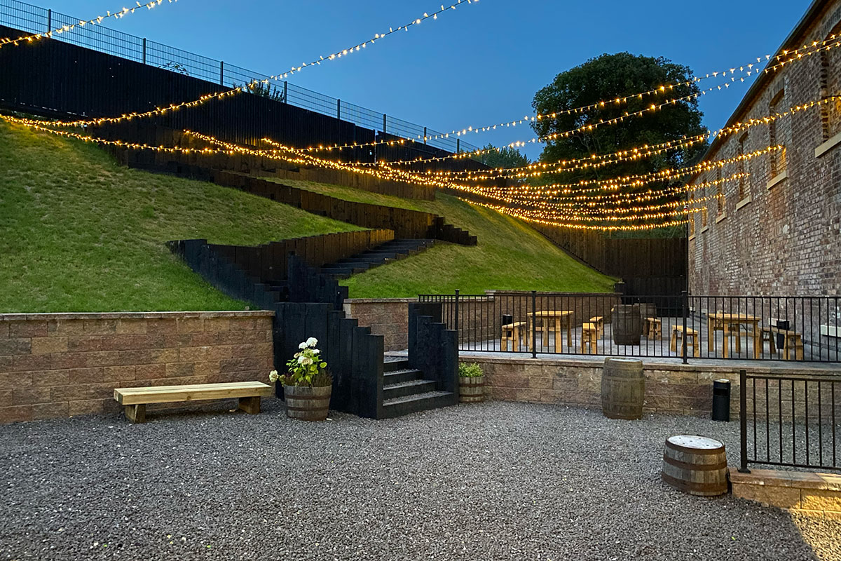 The Engine Works outdoor area with fairy lights and walled garden