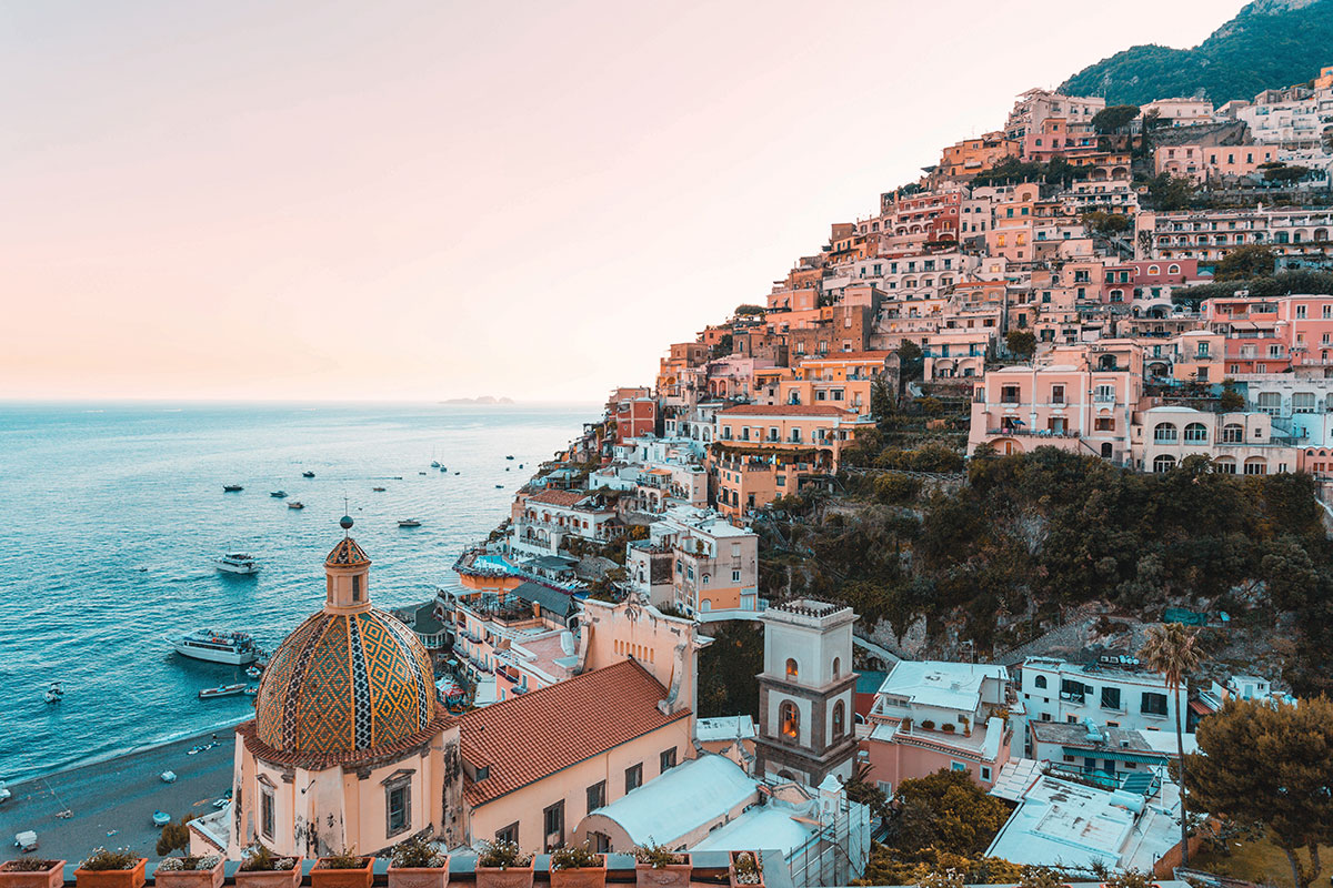 Pastel-coloured houses cascading down the cliffs towards the sea in Positano on Italy’s Amalfi Coast