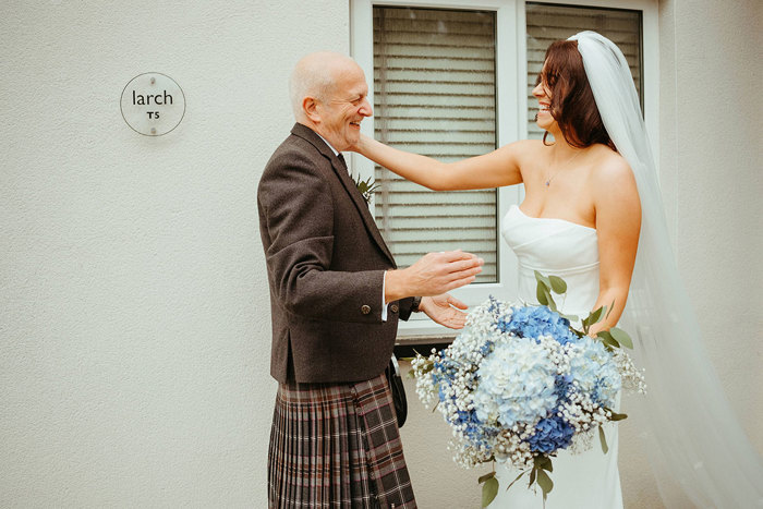 bride hugs dad during first look during wedding at dougarie boathouse