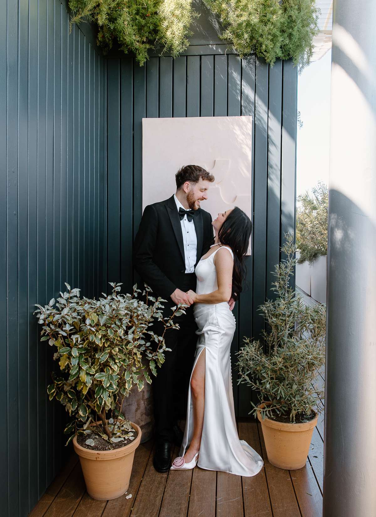Bride and groom pose together on the rooftop at The Hoxton Barcelona during their relaxed destination wedding after-party.
