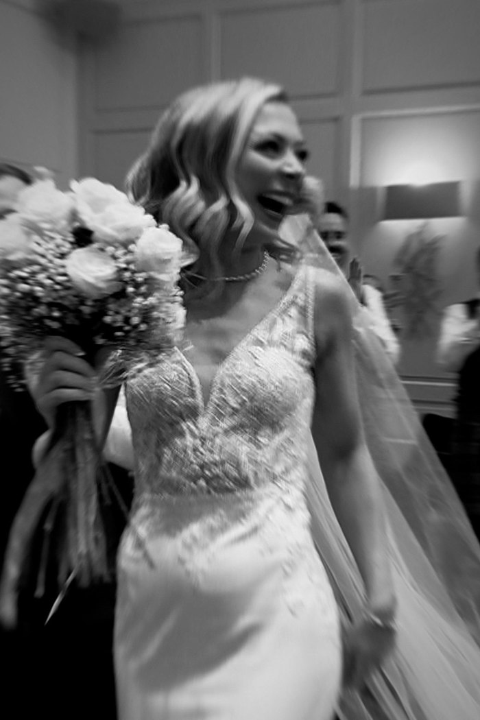 a black and white photo of a bride smiling