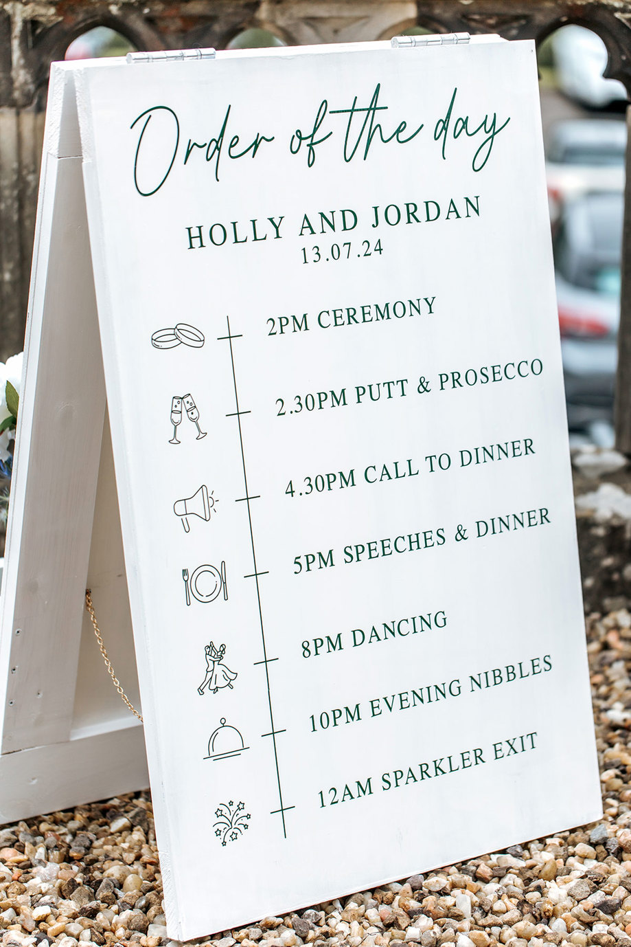 white order of the day wedding sign with green font at mar hall