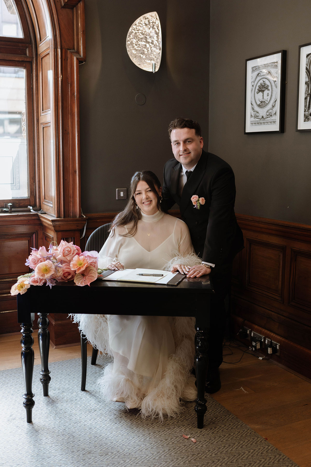 Bride and groom signing the marriage register during a stylish Glasgow city wedding