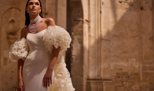 A person wearing a white dress. Veni Infantino Bridal Endless Love Collection