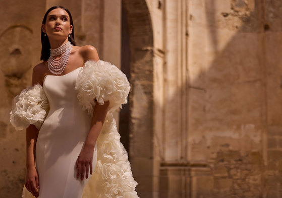 A person wearing a white dress. Veni Infantino Bridal Endless Love Collection