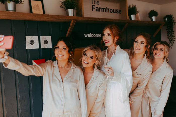 Bridesmaids take a selfie in their wedding morning pyjamas