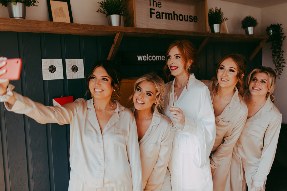 Bridesmaids take a selfie in their wedding morning pyjamas