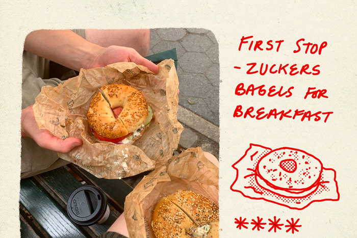 an overhead image of two bagels and a takeaway coffee on a bench with red animated writing on the side