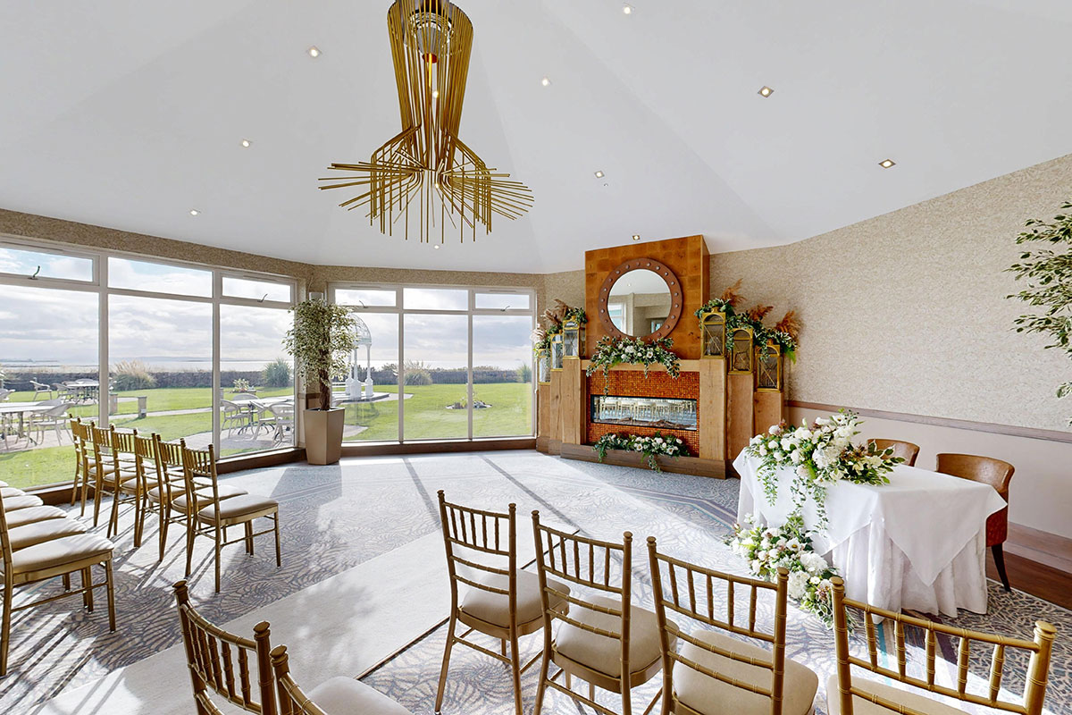Wedding ceremony setup in the Ailsa Lounge at The Waterside Hotel with sea views