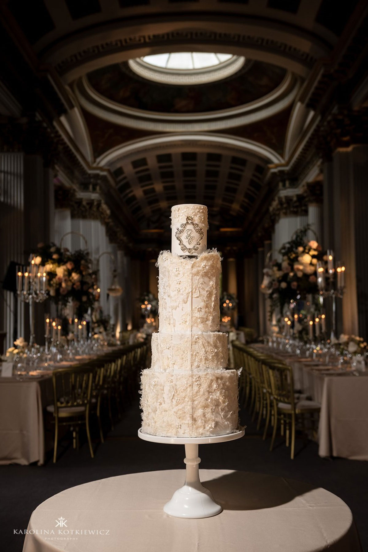a four tier wedding cake with edible lace inspired by the bride's dress, created by YiShi Cake