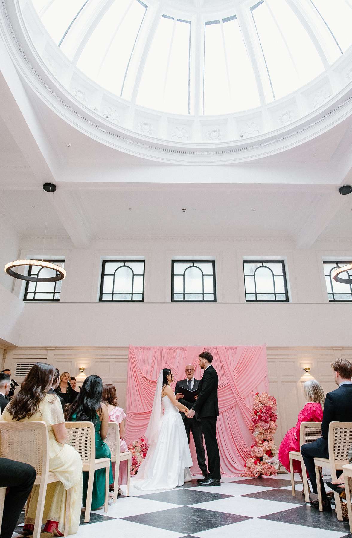 Bride and groom exchange vows beneath the domed ceiling of The Collector’s Hall during their intimate Glasgow wedding ceremony.