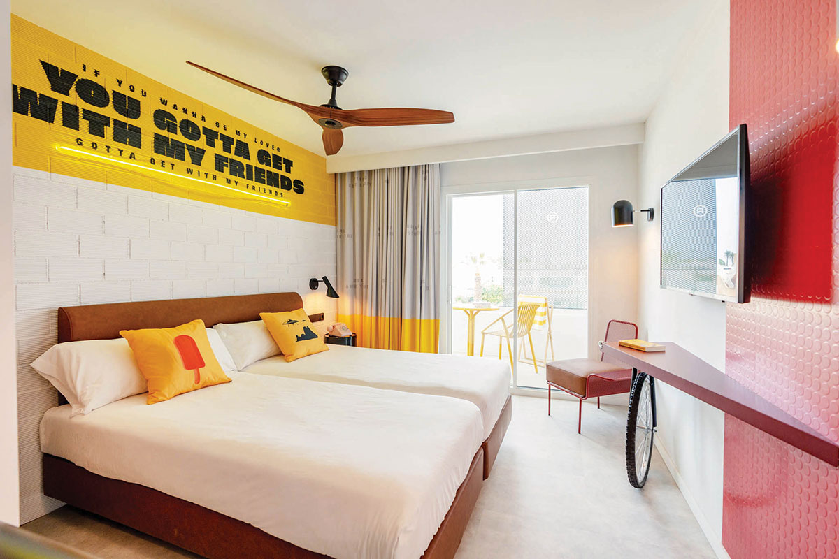 Bright and colourful twin bedroom with a balcony at Ryans Lolas Ibiza