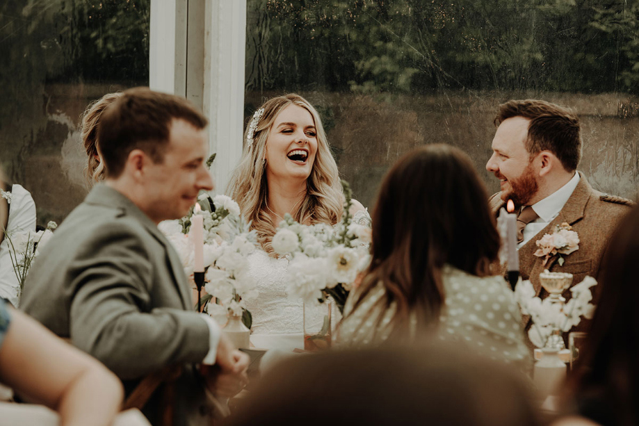 Bride laughing at top table