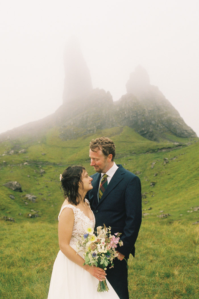 Bride and groom standing in the rain during outdoor wedding ceremony in scotland