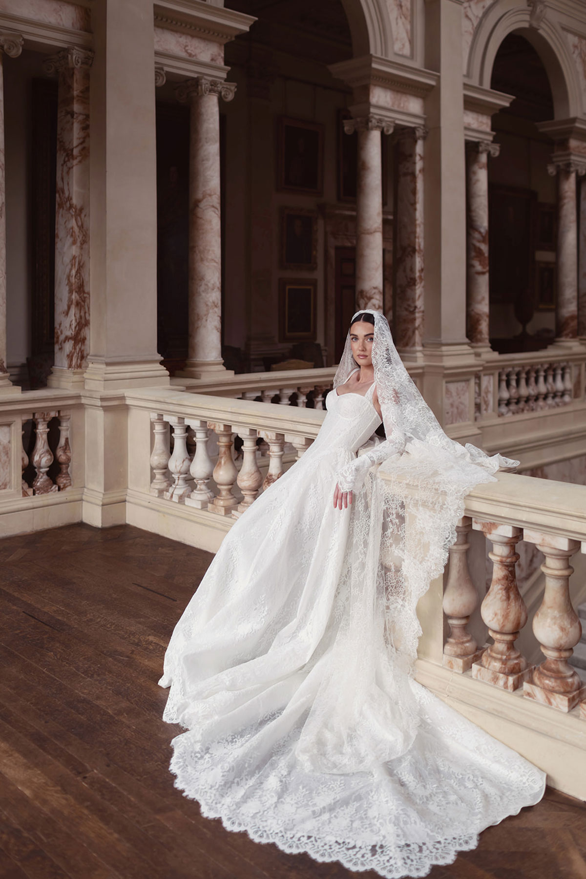 Close-up of a bridal model in a lace veil beside a window at Gosford House.