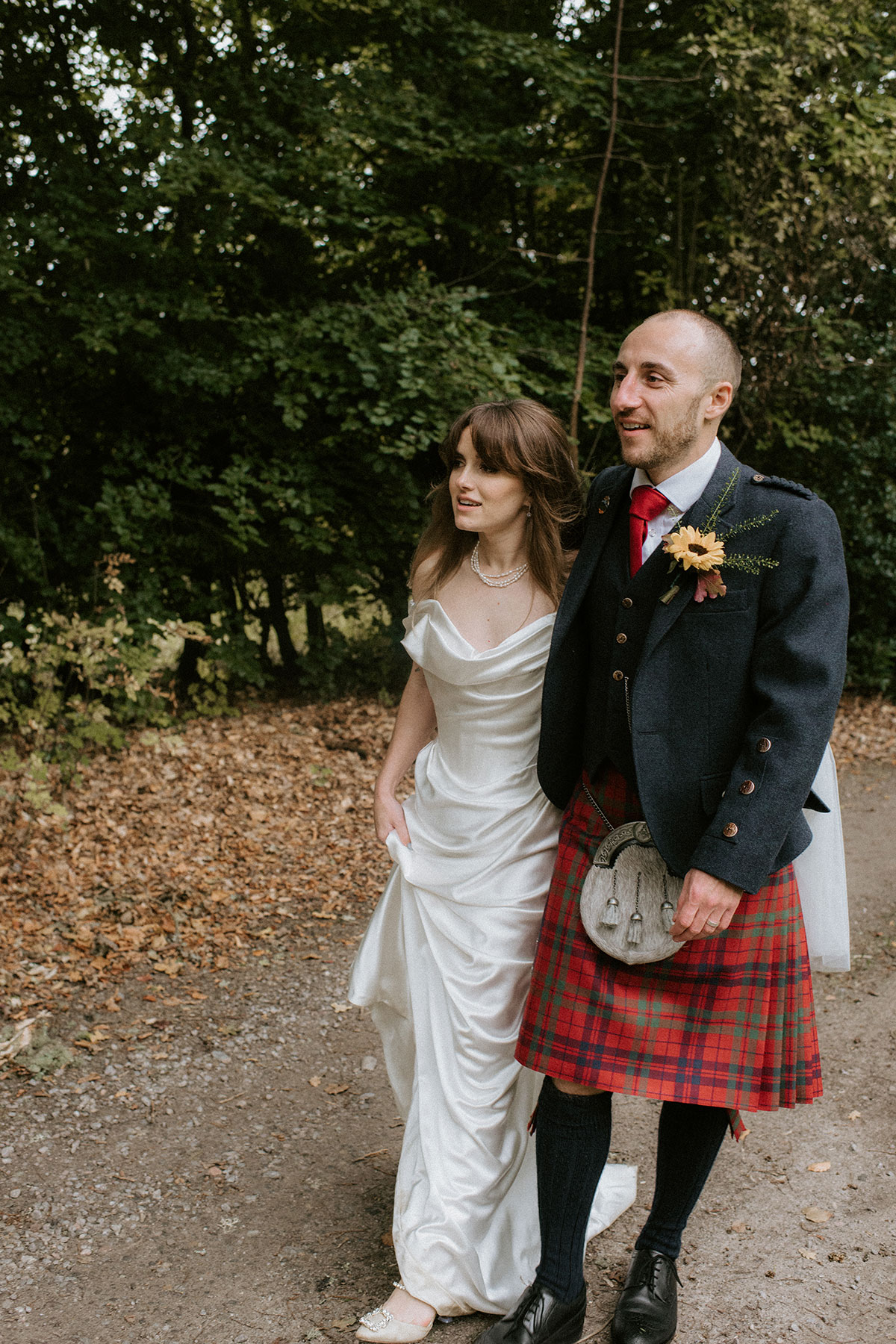 a bride and groom walking in gardens at Achnagairn Castle