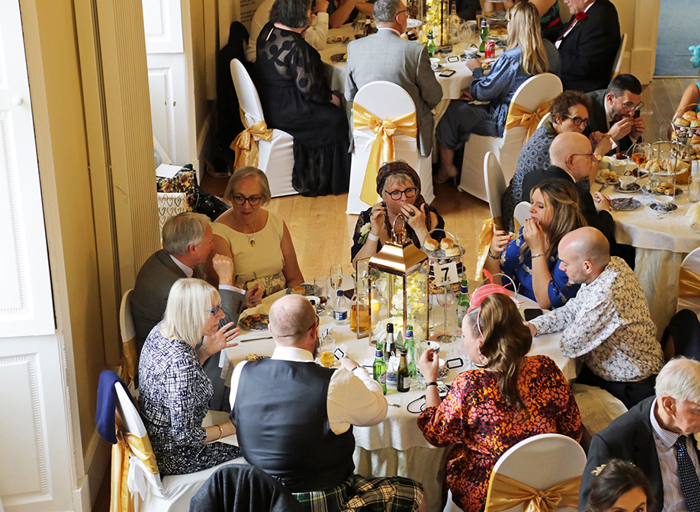 Tables with people sitting at them eating afternoon tea 