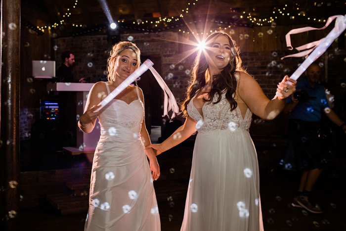 Brides dance with glow sticks during the evening