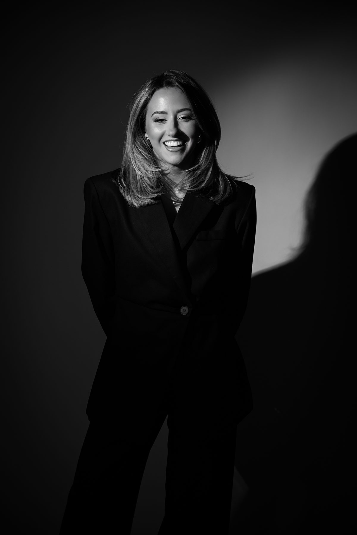 Dramatic monochrome photo of a Scottish wedding supplier in a tailored black suit