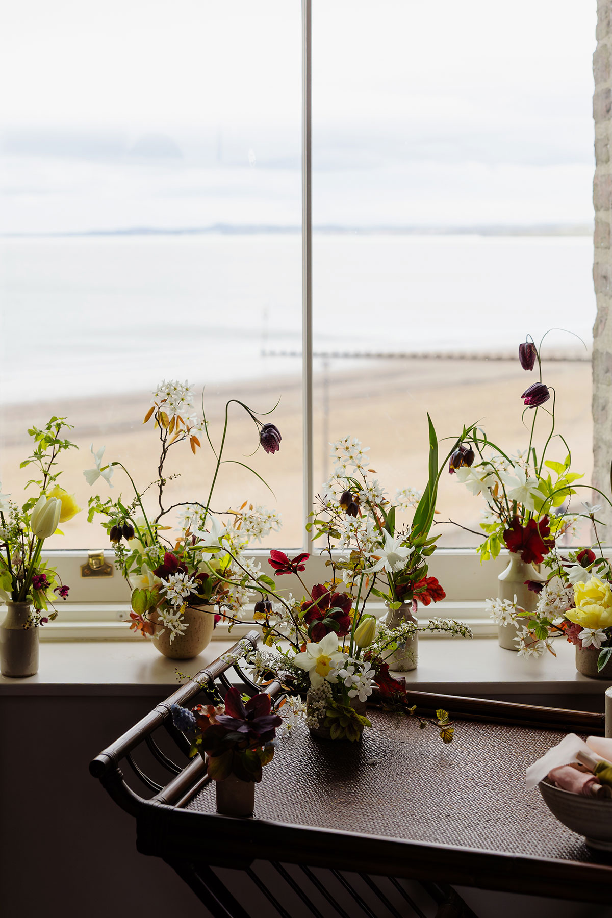 Wedding flowers on window ledge with Portobello beach view at The Tower