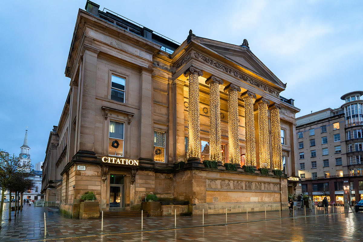 Citation wedding venue exterior in Glasgow city centre with illuminated columns at dusk