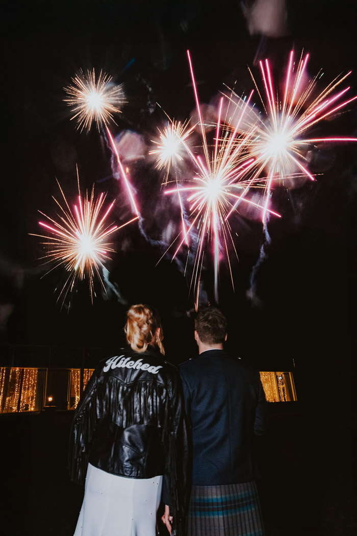 bride and groom pose for photographs with personalised jackets during wedding at Ardoe House 